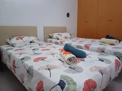two beds in a room with two beds sidx sidx sidx at Amplio duplex en la playa con piscina in Almarda