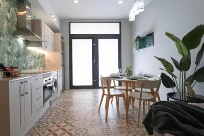 a kitchen with a table and chairs and a dining room at Apartment Teo in El Carmen in Valencia