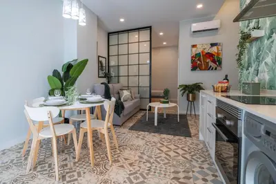 a kitchen and living room with a table and chairs at Apartment Teo in El Carmen in Valencia