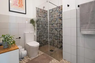 a bathroom with a toilet and a glass shower at Apartment Teo in El Carmen in Valencia