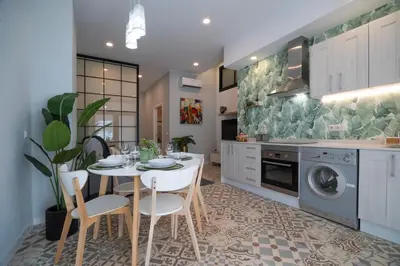 a kitchen with a table and chairs and a dishwasher at Apartment Teo in El Carmen in Valencia
