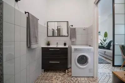 a bathroom with a washing machine and a sink at Apartment Teo in El Carmen in Valencia