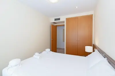 a bedroom with two beds and a closet at GuestReady - Lovely flat with views in Valencia in Valencia