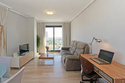 a living room with a desk with a laptop on it at GuestReady - Lovely flat with views in Valencia in Valencia