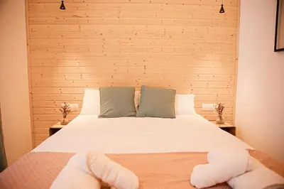 a bedroom with a bed with white sheets and pillows at Lofts Orense E Moderno y cercano a la playa in Valencia