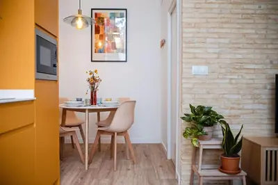a dining room with a table and chairs at Lofts Orense E Moderno y cercano a la playa in Valencia
