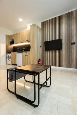a living room with a table and a kitchen at Vera Suites by Concept Flats in Valencia