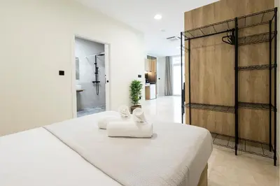 a bedroom with a white bed with two white towels at Vera Garden by Concept Flats in Valencia