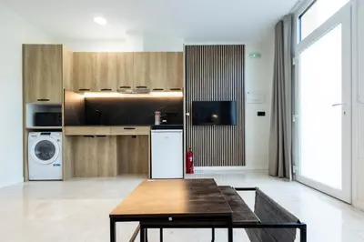 a kitchen with a table and a refrigerator at Vera Garden by Concept Flats in Valencia