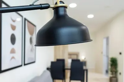 a black lamp hanging in a room with chairs at Vera Garden by Concept Flats in Valencia