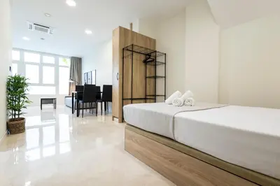 a bedroom with a bed and a dining room at Vera Garden by Concept Flats in Valencia