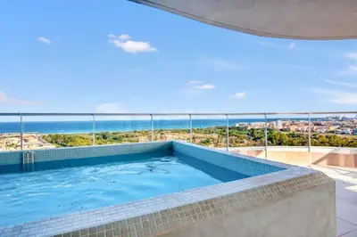 a swimming pool with a view of the ocean at Luxury Penthouse with Panoramic Sea Views in Canet de Berenguer
