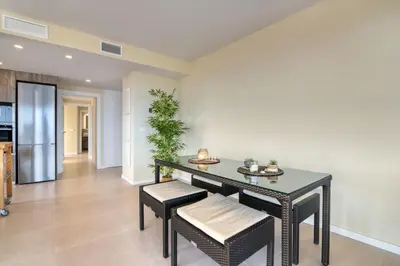 a dining room with a black table and chairs at Luxury Penthouse with Panoramic Sea Views in Canet de Berenguer