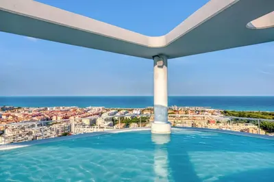 a swimming pool with a view of the ocean at Luxury Penthouse with Panoramic Sea Views in Canet de Berenguer