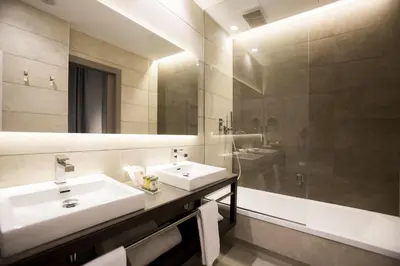 a bathroom with two sinks and a large mirror at Vincci Mercat in Valencia
