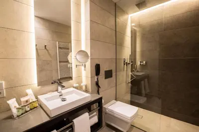 a bathroom with a sink and a toilet and a shower at Vincci Mercat in Valencia