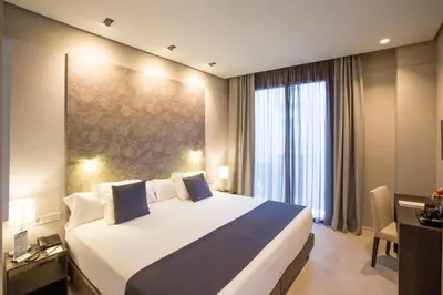 a hotel room with a large bed and a window at Vincci Mercat in Valencia
