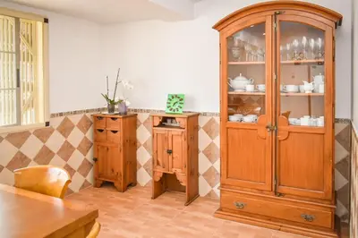 a kitchen with a wooden hutch and a table at Sunny House La Eliana in La Eliana