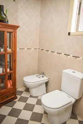 a bathroom with a toilet and a sink at Sunny House La Eliana in La Eliana
