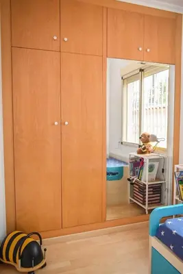a room with wooden cabinets and a mirror at Sunny House La Eliana in La Eliana