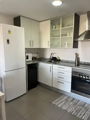 a kitchen with white cabinets and a white refrigerator at Apartamento en Moncofa in Moncófar