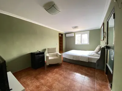 a bedroom with a bed and a chair at Guesthouse in Torrent in Valencia