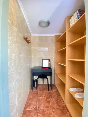 a room with a desk with a computer on a shelf at Guesthouse in Torrent in Valencia