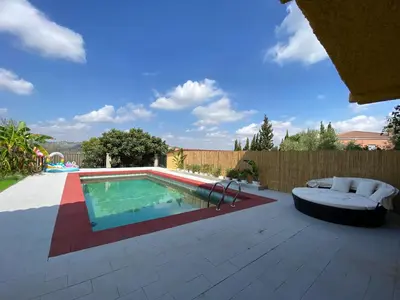 a backyard with a swimming pool and a fence at Guesthouse in Torrent in Valencia