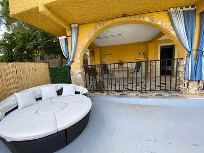 a large white couch sitting on a patio at Guesthouse in Torrent in Valencia