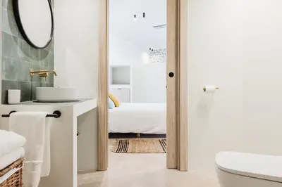 a bathroom with a toilet and a sink and a mirror at Loft Viñas in Valencia