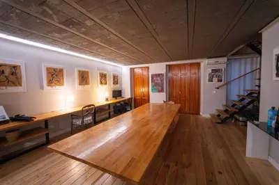 a large room with a wooden table and a desk at Duplex Loft And Home Office 140m2 plus a 70m2 Terrace in Valencia