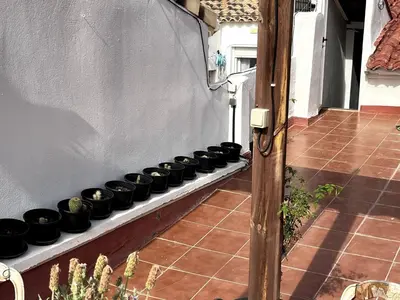 a row of black pots sitting on a shelf at Duplex Loft And Home Office 140m2 plus a 70m2 Terrace in Valencia