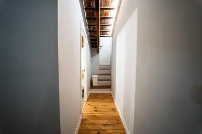 a hallway with white walls and wooden floors at Duplex Loft And Home Office 140m2 plus a 70m2 Terrace in Valencia