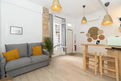 a living room with a couch and a table at Illetes Flats -Apartamento con mucho encanto in Valencia
