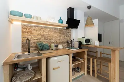 a kitchen with a sink and a counter top at Illetes Flats -Apartamento con mucho encanto in Valencia