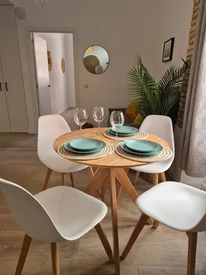 a dining room with a table and white chairs at Illetes Flats -Apartamento con mucho encanto in Valencia