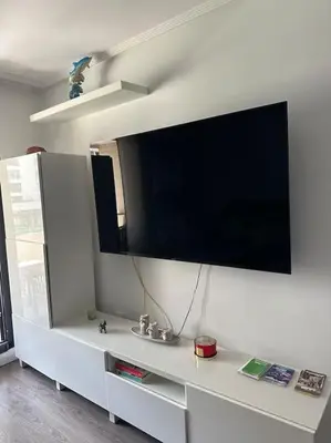 a living room with a large tv on a wall at Apartamento playa Veramar patacona in Valencia