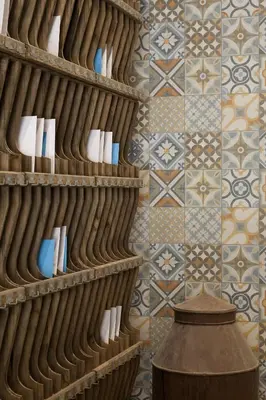a room with a tile wall and shelves with books at Hotel Boutique Balandret in Valencia