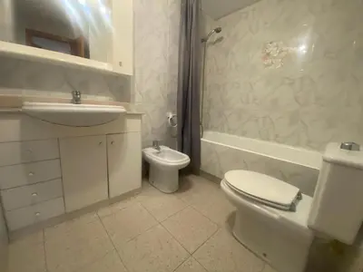a bathroom with a sink and a shower and a toilet at Voramar Serviplaya Solo Familias in Casas Las Basas