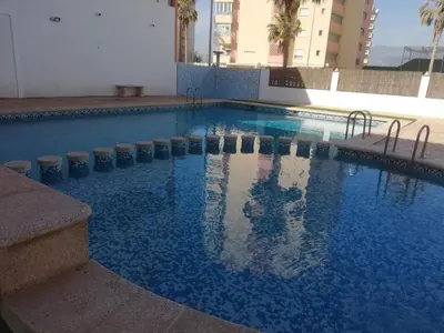a white house with a white fence at Voramar Serviplaya Solo Familias in Casas Las Basas