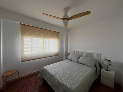a bedroom with a bed and a ceiling fan at Tu Refugio con Vistas al Mar in Puebla de Farnals