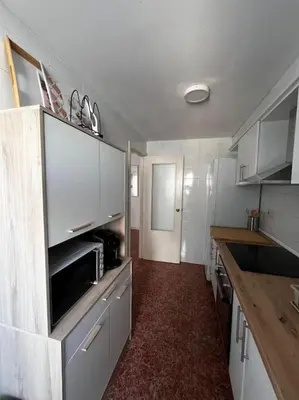 a kitchen with a microwave and a counter in it at Tu Refugio con Vistas al Mar in Puebla de Farnals