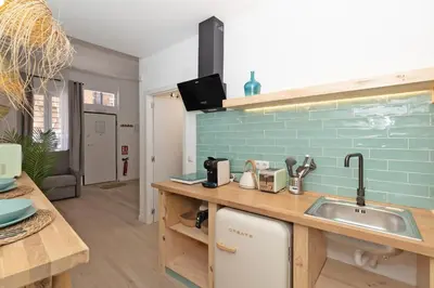 a kitchen with a sink and a blue brick wall at Illetes Flats - Loft encantador cerca de Bioparc in Valencia