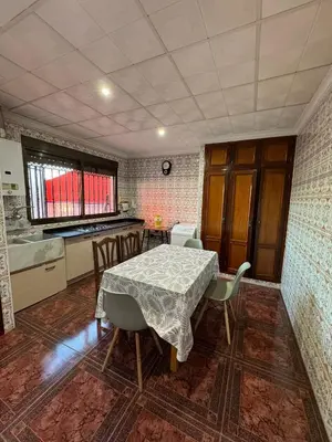 a kitchen with a table and chairs in a room at Casa Rural Piker in Bolbaite