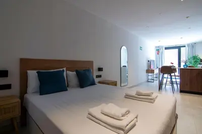 a bedroom with a large bed with towels on it at VLC HOST - Luz Casanova in Valencia