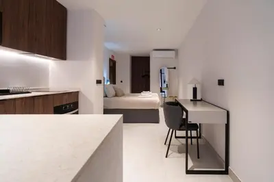 a kitchen with a desk and a room with a bed at VLC HOST - Luz Casanova in Valencia