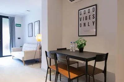 a dining room with a table and chairs and a couch at VLC HOST - Luz Casanova in Valencia