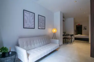 a living room with a white couch and a table at VLC HOST - Luz Casanova in Valencia