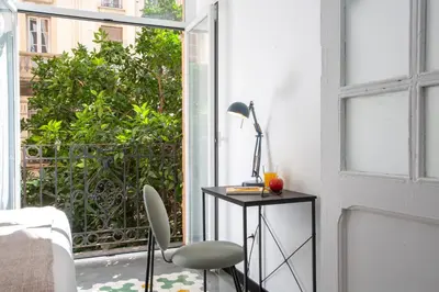 a room with a desk with a lamp and a window at SingularStays Ca Iconic Living in Valencia