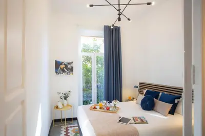 a bedroom with a large bed with a window at SingularStays Ca Iconic Living in Valencia